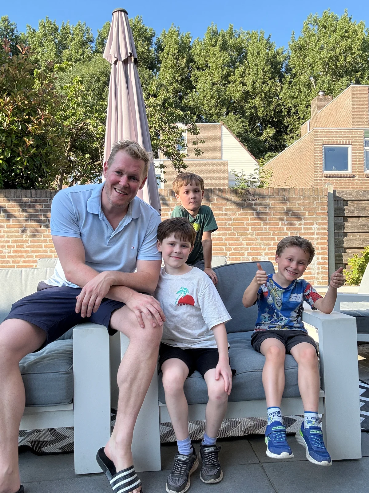 Bas with his three sons in the garden